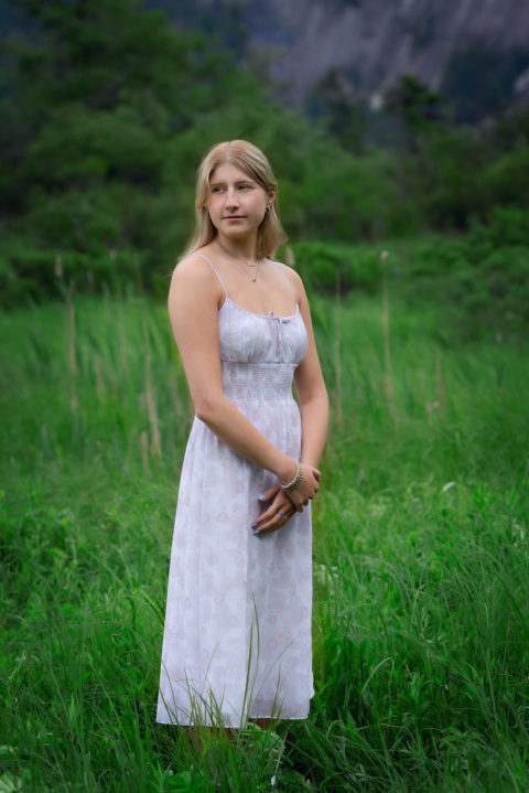 Family Portrait girl in white dress with arms crossed in front looking to the left