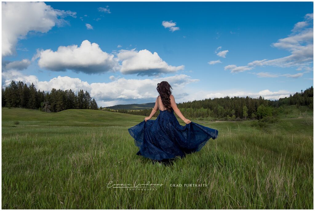 Maleah walking away in a flowing blue dress, symbolizing new beginnings after graduation.